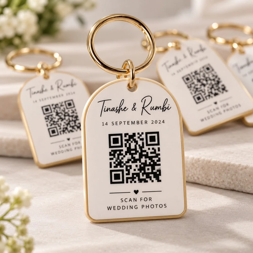 Cream and gold-toned wedding keychain with example names, date and an illustrative photo-album QR code