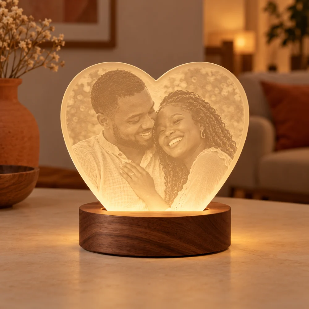 Illustrative heart-shaped photo lamp glowing warmly on a wooden base
